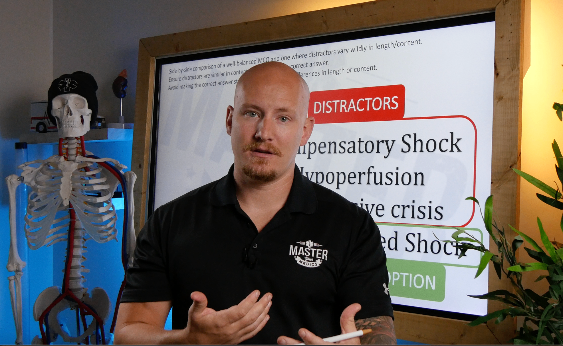 Master Your Medics instructor teaching EMS curriculum with anatomical skeleton and presentation screen